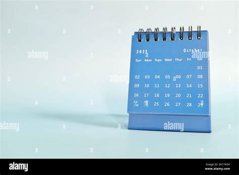 Selective Focus Of October 2022 Desk Calendar On Green Background With