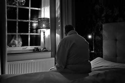 Premium Photo Rear View Of Man Sitting On Bed At Home