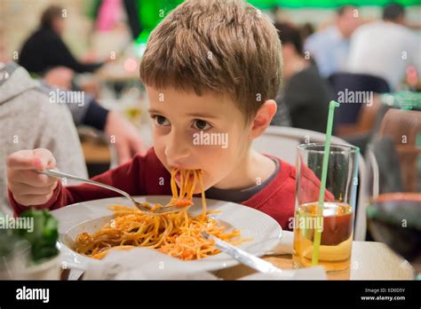 Boy Sitting In A Restaurant Eating Spaghetti Stock Photo Alamy