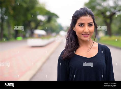 Happy Young Beautiful Persian Woman Relaxing At The Park Stock Photo