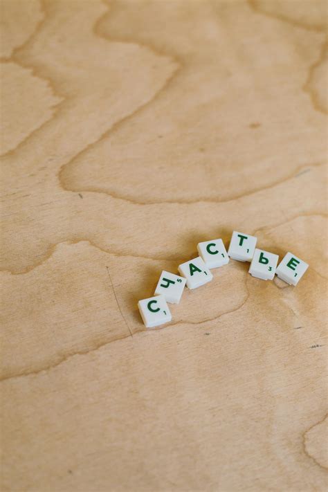 Photo Of Scrabble Pieces On Wooden Surface · Free Stock Photo