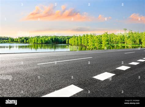 Empty Asphalt Road And Green Forest And River Natural Landscape Stock