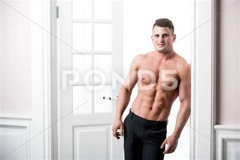 Portrait Of A Well Built Shirtless Muscular Male Model Looking Straight