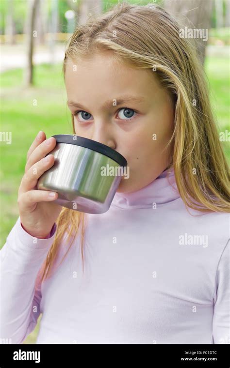 Cute Girl Drinking Beverage Stock Photo Alamy