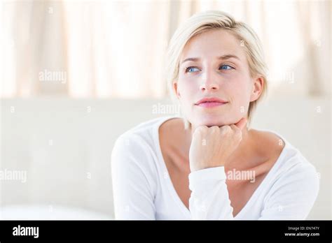 Pretty Blonde Woman Sitting On The Bed Stock Photo Alamy