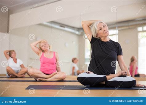 Group Of Mature Women Exercising In Lotus Pose Stock Image Image Of