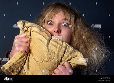 A frightened young woman watching a horror movie Stock Photo - Alamy