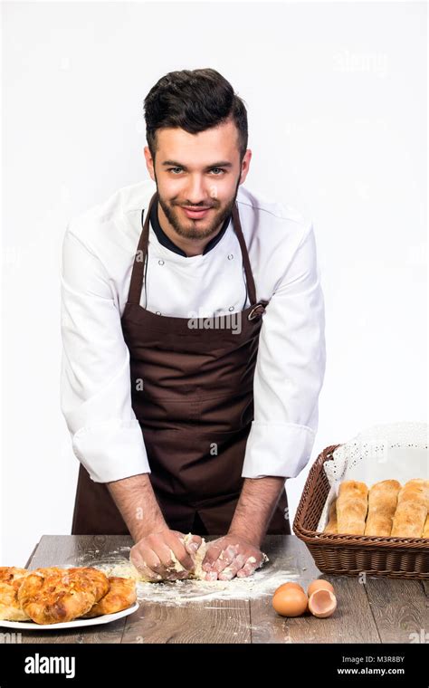 A Man In An Apron Prepares The Dough For Baking Cook Model On A White