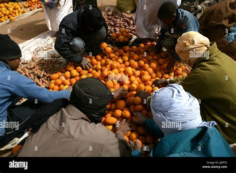 Men Buying Oranges At The Mhamid Market Stock Photo Alamy