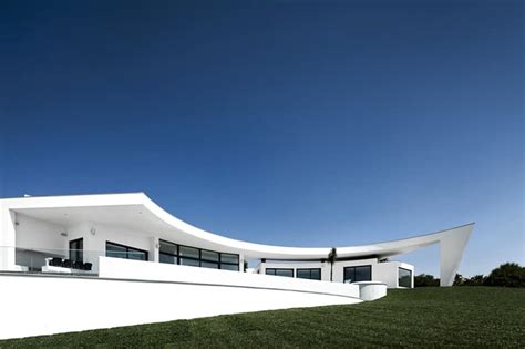 Arc House With Luxury Interiors And Edgy Curved Roof