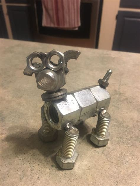 A Metal Dog Made Out Of Nuts And Bolts On Top Of A Kitchen Countertop