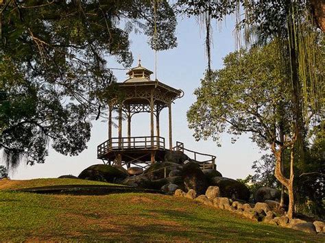 A Gazebo On Top Of A Hill Surrounded By Trees