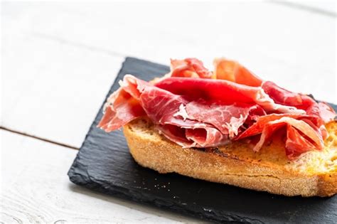 Premium Photo Tapa Or Portion Of Acornfed Iberian Ham Typical Spanish