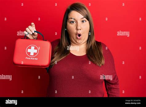 Beautiful Brunette Plus Size Woman Holding First Aid Kit Scared And