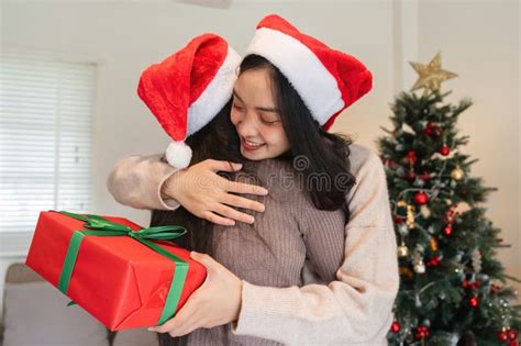 Joyful Lesbian Couple Celebrating Christmas Together With Gifts And Holiday Cheer In A Festive