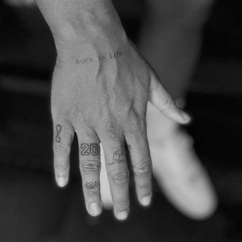 Fine line tattoos located on Sam Kerr's fingers.