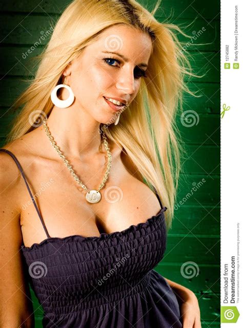 Blonde Woman Fashion Model Showing Cleavage In Low Cut Blue Top