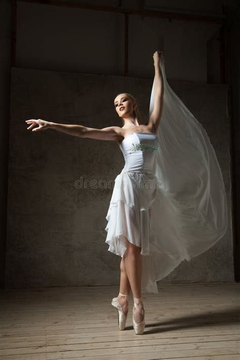 Beautiful Ballet Dancer In White Costume With Waving Skirt Dancing