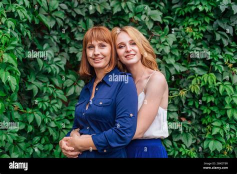 Beautiful Mother And Her Grown Up Daughter Hugging Each Other On A