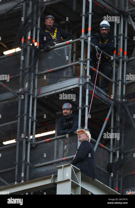 An Extinction Rebellion Protester Who Has Scaled The Scaffolding