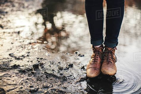 Close Up Of Woman Standing In Puddle Stock Photo Dissolve