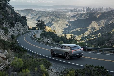 Luxury SUV driving on a scenic mountain road with a city view ideal for ...