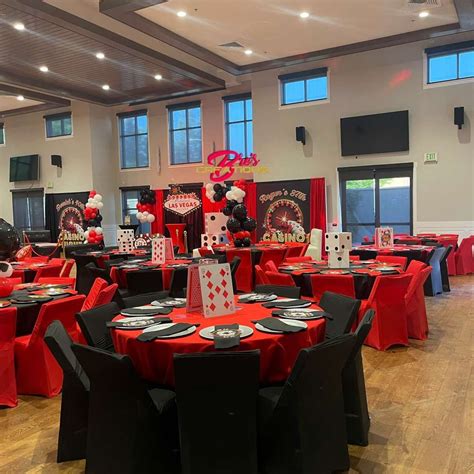 a banquet hall decorated with red and black table cloths, mickey mouse ...