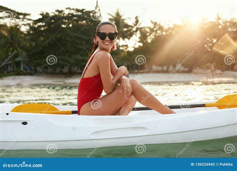 Summer Fashion Woman In Red Swimwear And Sunglasses On Kayak Stock