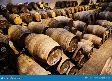 Old Aged Traditional Wooden Barrels With Wine In A Vault Lined Up In