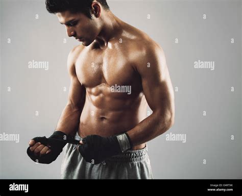 Young Male Boxer Wrapping His Hands In Boxing Tape Before A Fight Stock