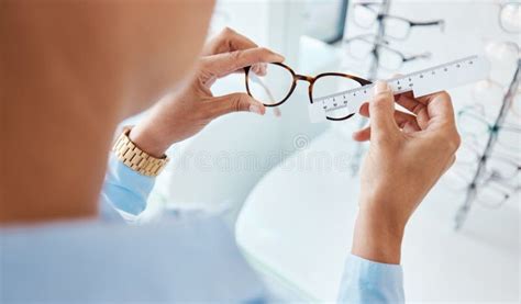 Optician Or Optometrist Hands Measuring And Preparing Pair Of Glasses And Frame With Optic Ruler