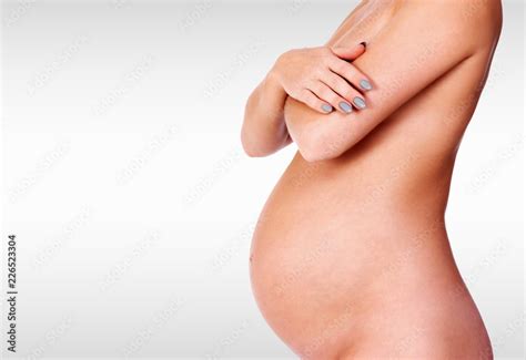 Naked Pregnant Woman Posing Against A Grey Background With Copyspace Stock Photo Adobe Stock