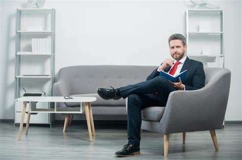 Premium Photo Smiling Mature Businessman In Suit Sit In Office