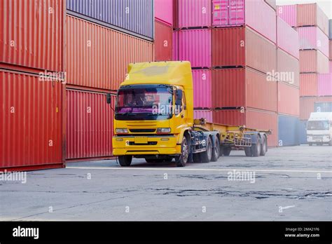 Trucks in container yard as transportation view Stock Photo - Alamy