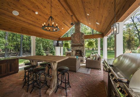 Stunning rustic outdoor living space complete with fireplace, grill ...