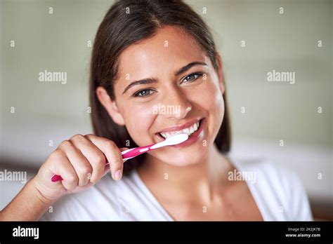 Minty Fresh Portrait Of A Beautiful Woman Brushing Her Teeth In The