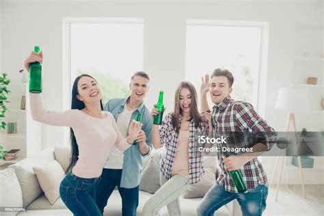 Four Attractive Nice Young Joyful Happy Smiling Friends Two Guys Two Girls Dancing At Home Party