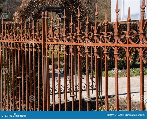 Wrought Iron Garden Fence With Rusty Patina With Spikes And Arches