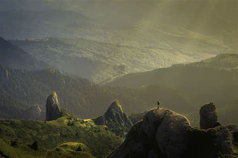 landscape photography mountain hit sun rays person standing top