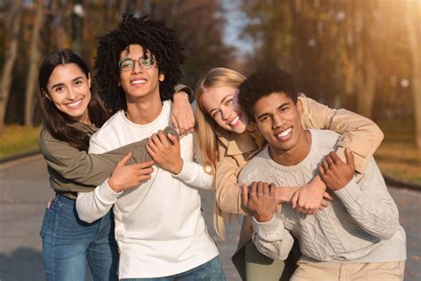 Two Multiracial Teen Couples Cuddling At Park Cedar Tree Counseling Ltd