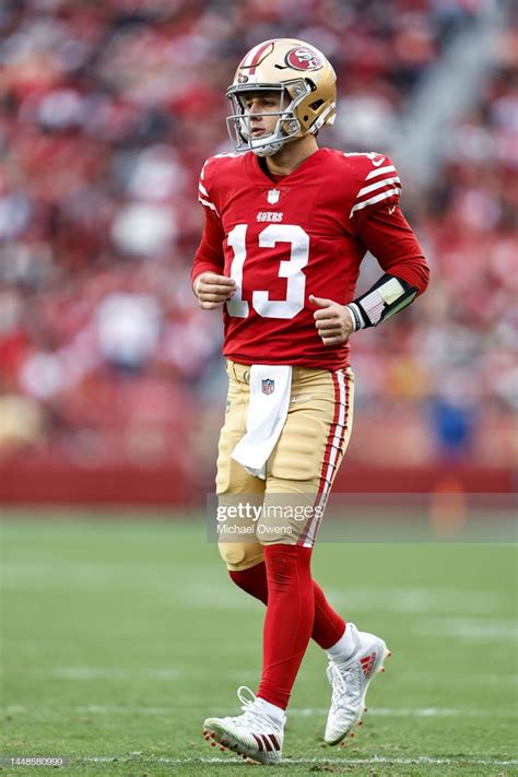 A Football Player Running On The Field During A Game Stock Photos And