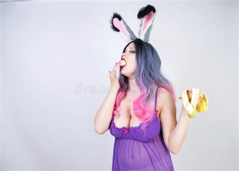 Erotic Banana And Donut In The Hands As A Symbol Of The Penis And Vagina Isolated On A White