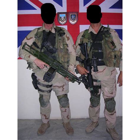 British SAS personnel pictured in front of a Union Jack and crests for 264 (SAS) Squadron (left ...