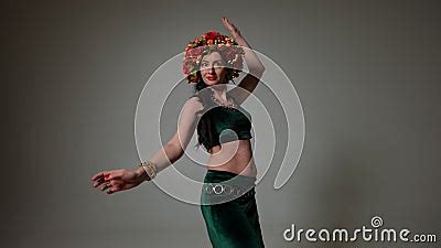 Back View Smiling Mature Woman Turning Looking At Camera Moving Hips Dancing Belly Dance At Grey