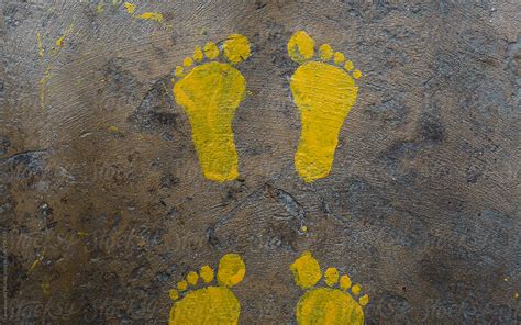 "Painted Yellow Footprints In The Waiting Area" by Stocksy Contributor "Lawrence Del Mundo ...