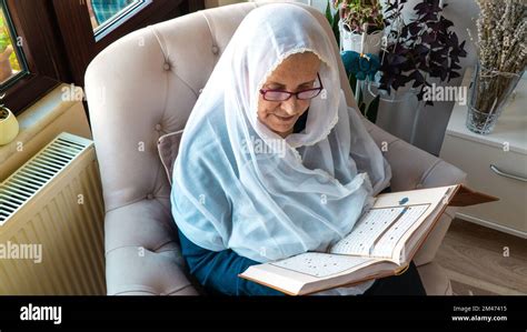 Old Muslim Woman Reading The Holy Quran At Home During Ramadan Month