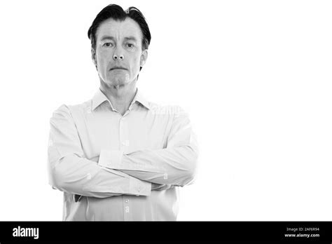 Studio Shot Of Mature Handsome Businessman With Arms Crossed Stock