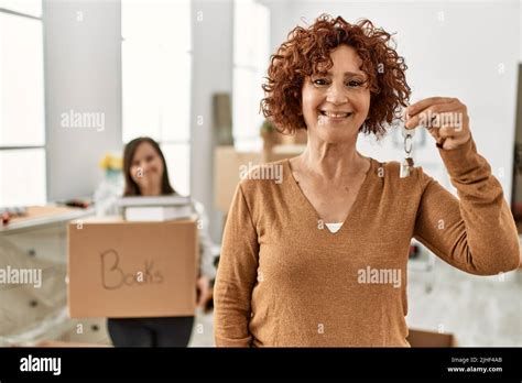 Mature Mother And Down Syndrome Daughter Moving To A New Home Standing