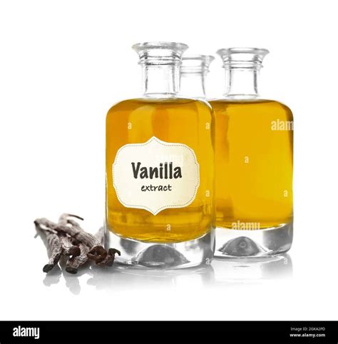 Bottles With Aromatic Extract And Dry Vanilla Beans On White Background