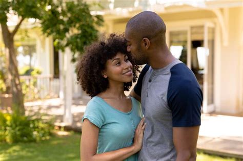 Premium Photo Happy Young Couple Holding Each Other In The Garden